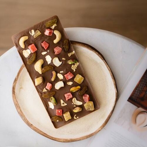 A dry fruit chocolate bar on a plate