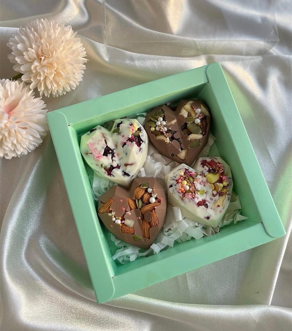 A green gift box of Big Bites in white and milk chocolate