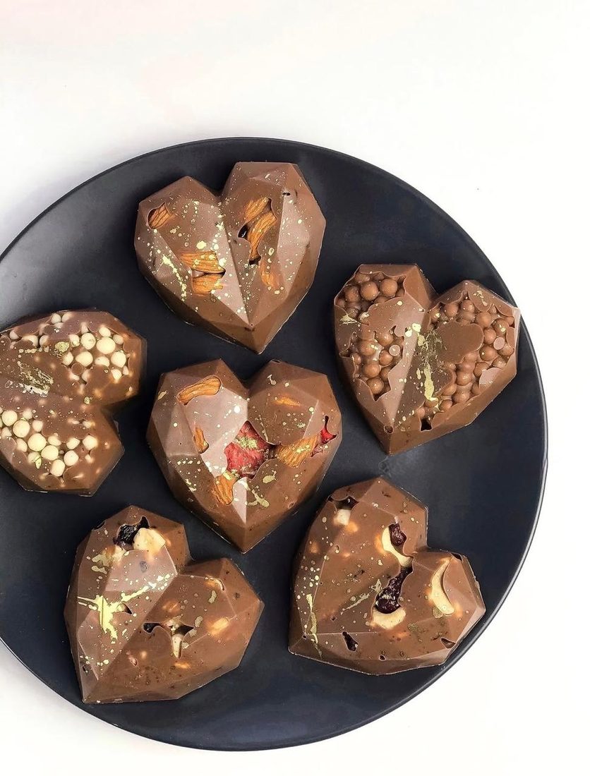 Big Bites on a dark plate, topped with nuts and dried fruit