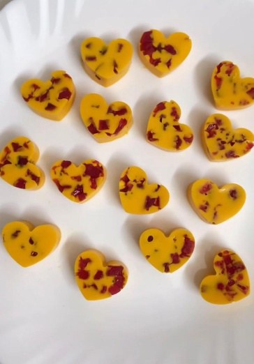 Heart shaped mango chocolates studded with red fruit pieces
