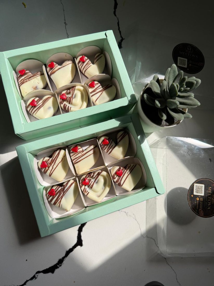 Two mint green boxes of customised bites with a cherry finish