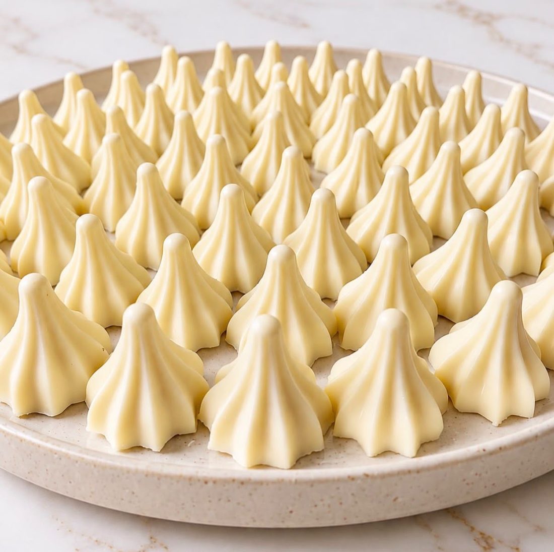 A plate of white chocolate modaks